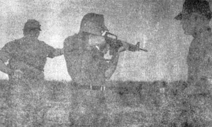 Lt. Col. Lewis J. North fires M-16