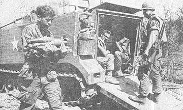 SP4 Ronald Kromer carries rockets