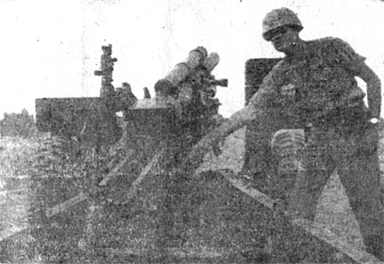 Maj. Frank Deam fires howitzer