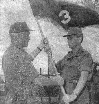 BG Glenn Walker hands flag to Col. James Shanahan