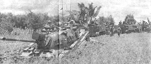3rd Brigade tracks pull tank from mudhole